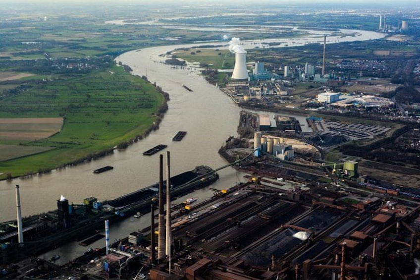 A river with industrial facilities and a cooling tower. 2