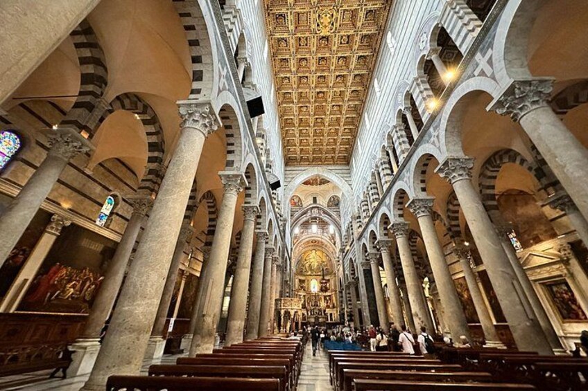 A grand cathedral interior with high ceilings, arched columns, and a central altar. 5