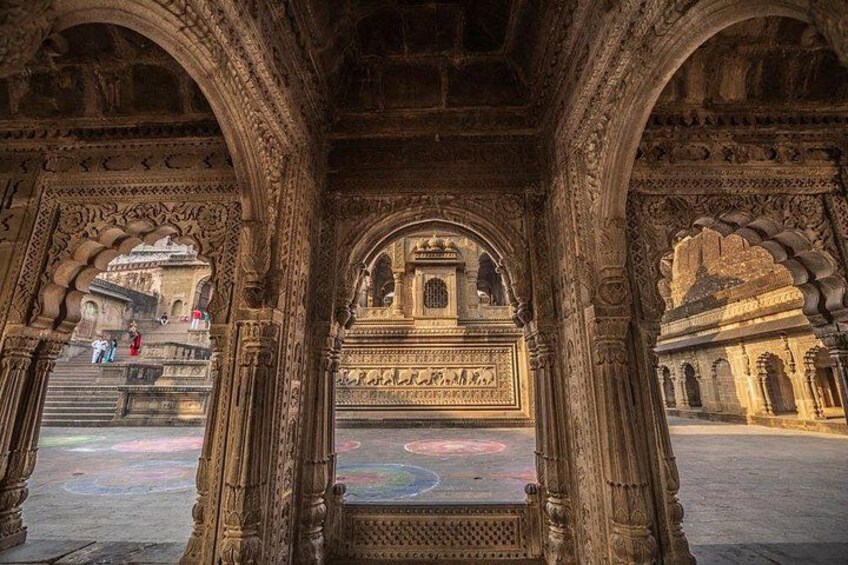An ornate architectural structure with intricate carvings and a central archway. 4