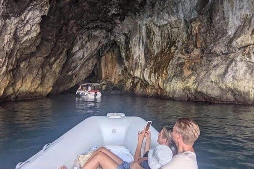 A cave with a boat in the water. 3