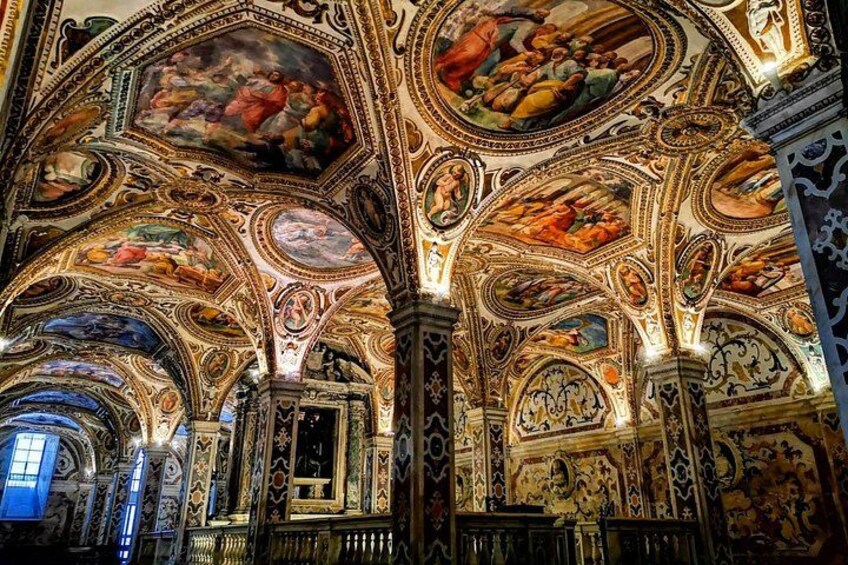 An ornate interior with detailed frescoes and architectural elements. 1