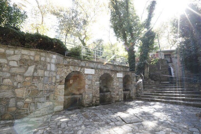 A stone bridge with arched passageways and a staircase leading up. 5