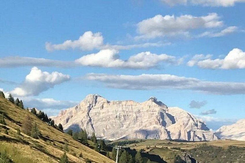 A mountain range with clear skies and a few clouds. 4