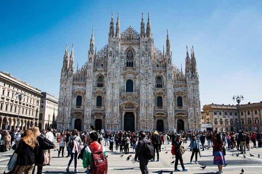 A large, ornate cathedral with multiple spires and a crowd of people in front. 4