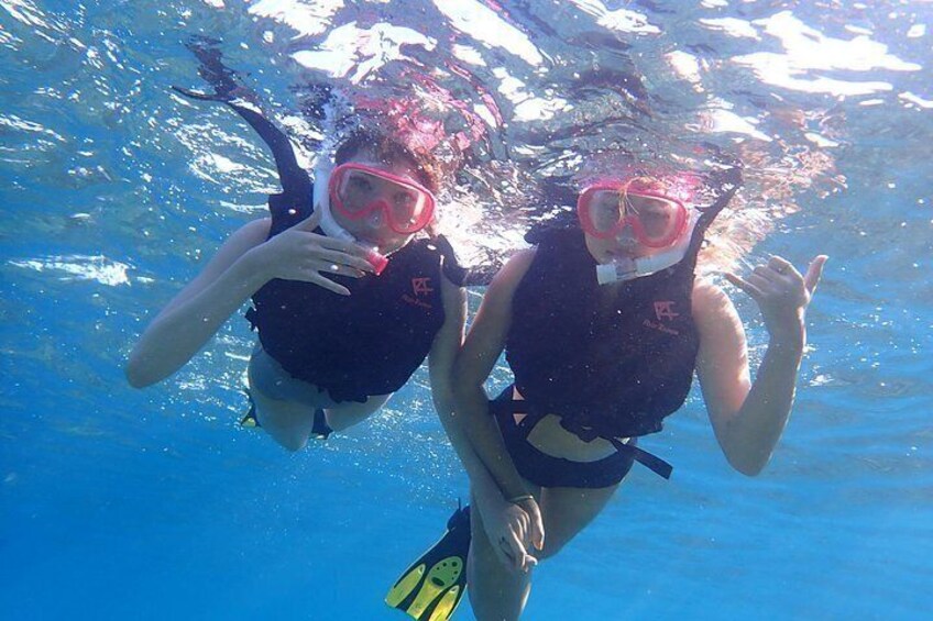 Two people snorkeling underwater. 2