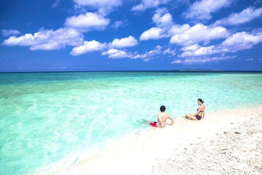 A beach with clear turquoise water and a sandy shore. 3