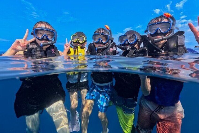 A group of people snorkeling underwater. 3