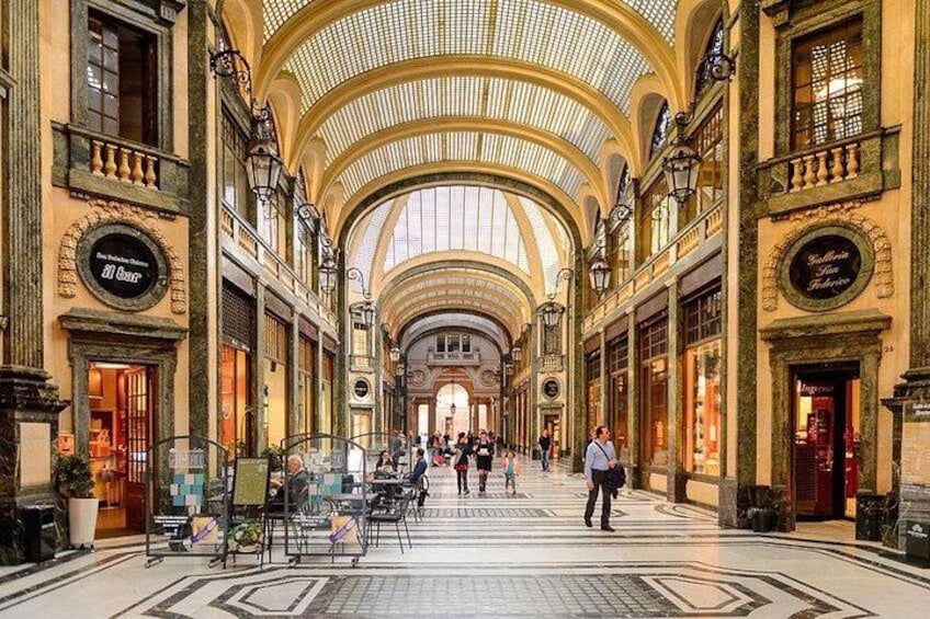 A spacious indoor market with high ceilings and ornate architecture. 2