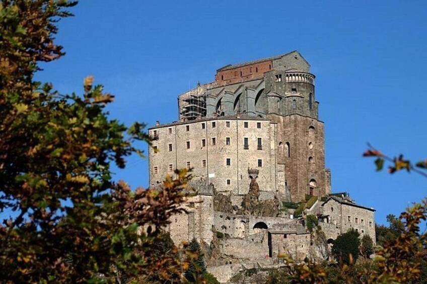 A historic castle with a prominent tower, surrounded by trees. 4