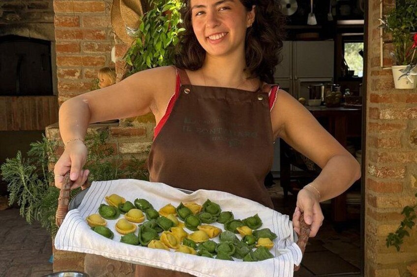 A person holding a tray with green and yellow bell peppers. 2