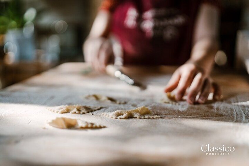 Hands shaping dough on a wooden surface. 5
