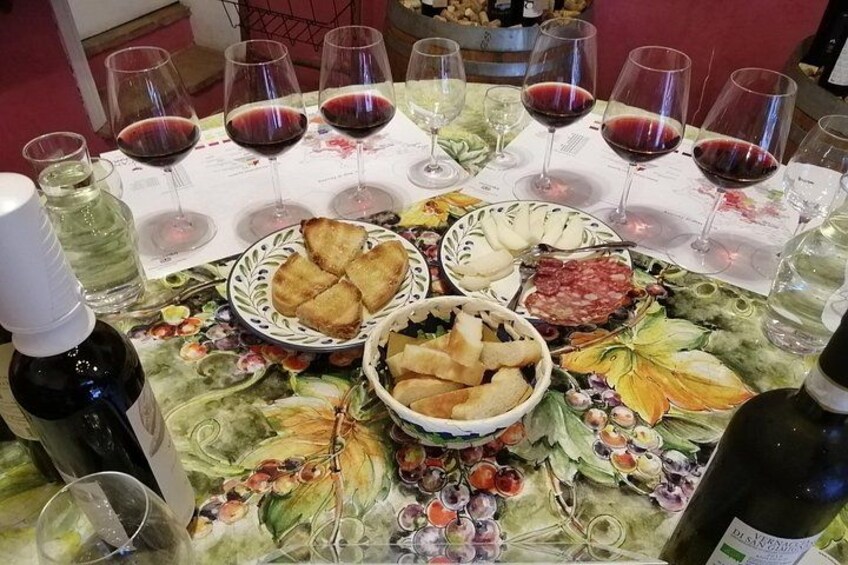 A table with wine glasses, bread, and charcuterie. 4