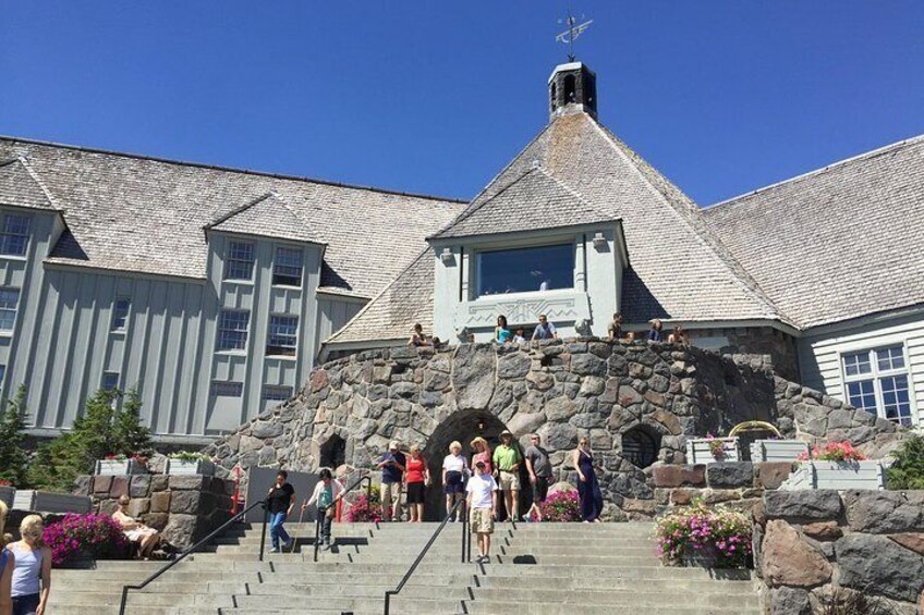 A building with a stone facade, a steep staircase, and a clear blue sky. 3