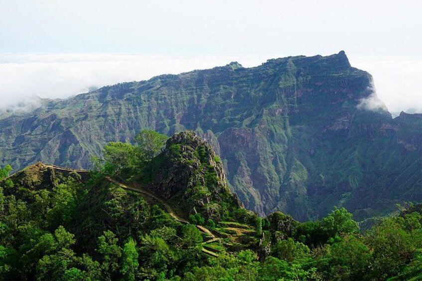 A mountainous landscape with lush greenery and terraced fields. 4