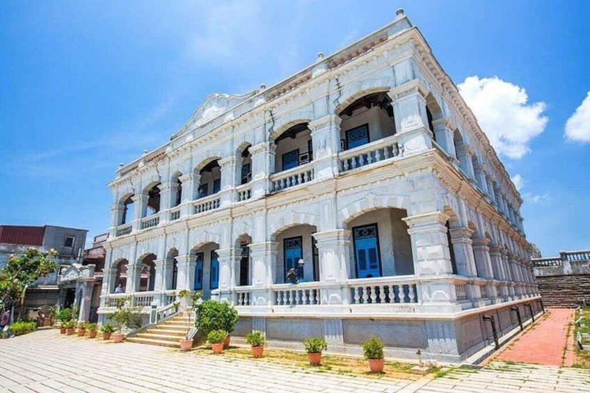 A historic building with multiple arches and a balcony. 4