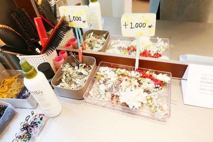A display of hair accessories and flowers with price tags. 4