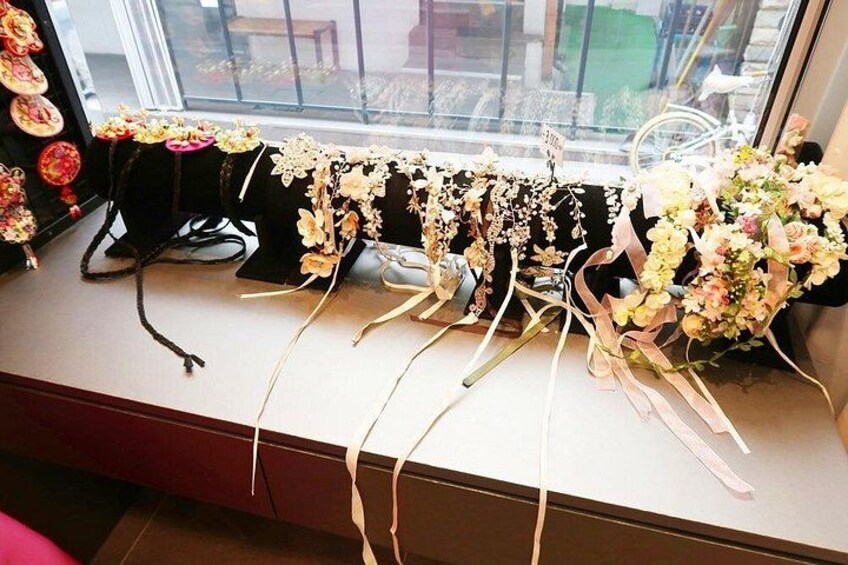 A display of floral arrangements on a table near a window. 5