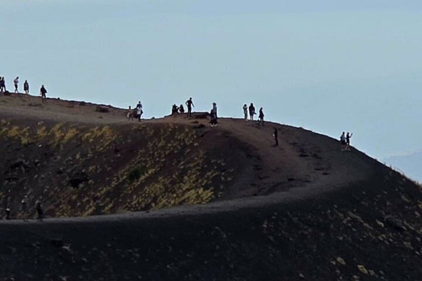 A group of people on a hill with a clear sky. 5