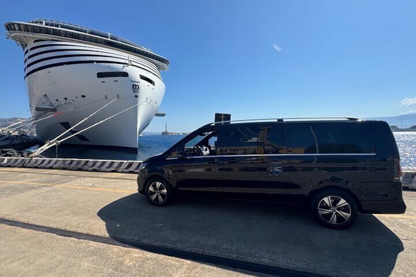 Un fourgon noir était garé devant un grand bateau blanc, sur lequel on pouvait lire les lettres « MSC ». 1