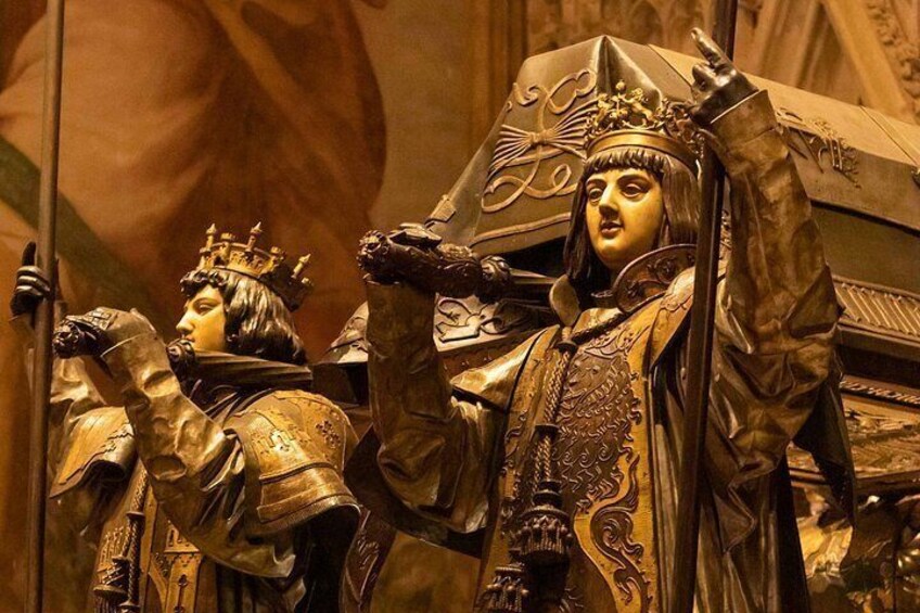 A statue of a figure in armor with a crown, holding a staff. 3