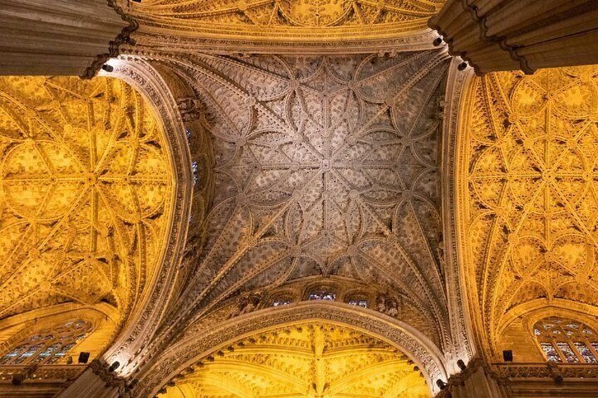 An ornate ceiling with intricate patterns and a central circular design. 5