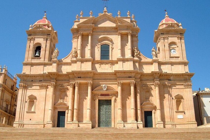 A large, ornate church with a central dome, two bell towers, and a large entrance. 4