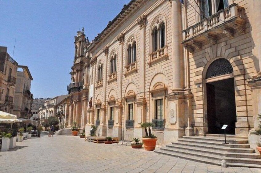 A historic building with arched windows and a grand entrance. 5