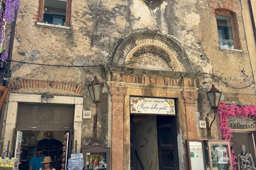 A historic building with a sign reading 'Museo della pasta.' 3