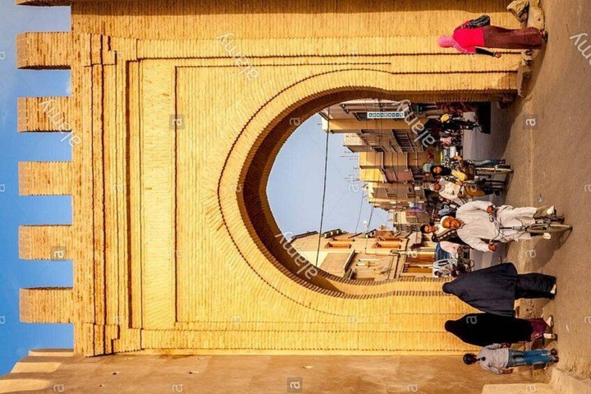 A large archway with people walking through it. 5