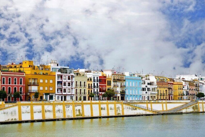 A waterfront with colorful buildings and a bridge. 1