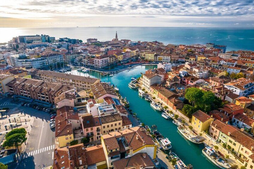 A coastal cityscape with a prominent river, historic buildings, and a clear sky. 2