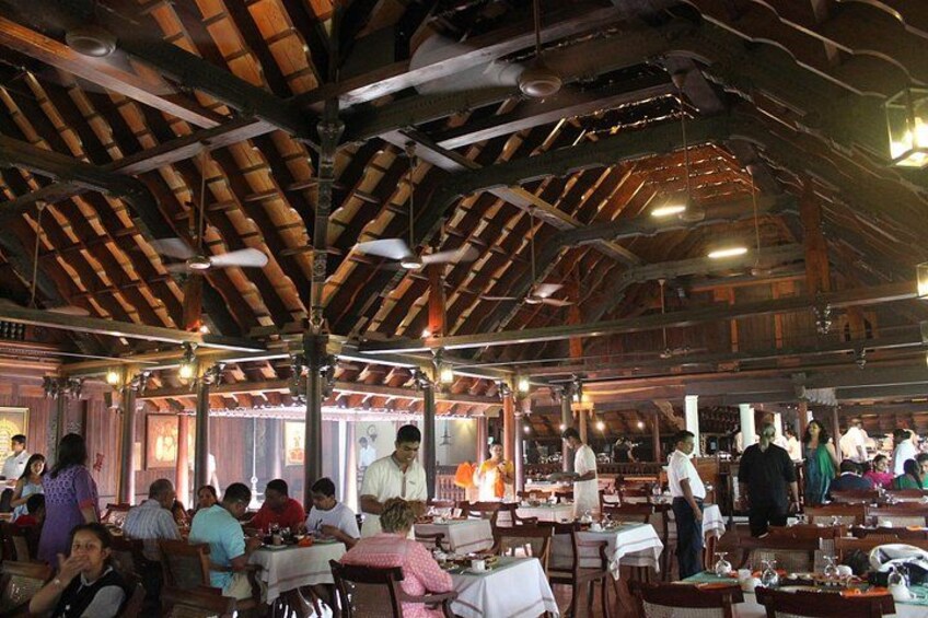 A rustic dining area with wooden beams and tables set for multiple diners. 3
