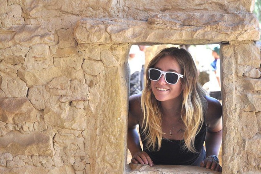 A person peeking through a stone archway. 2