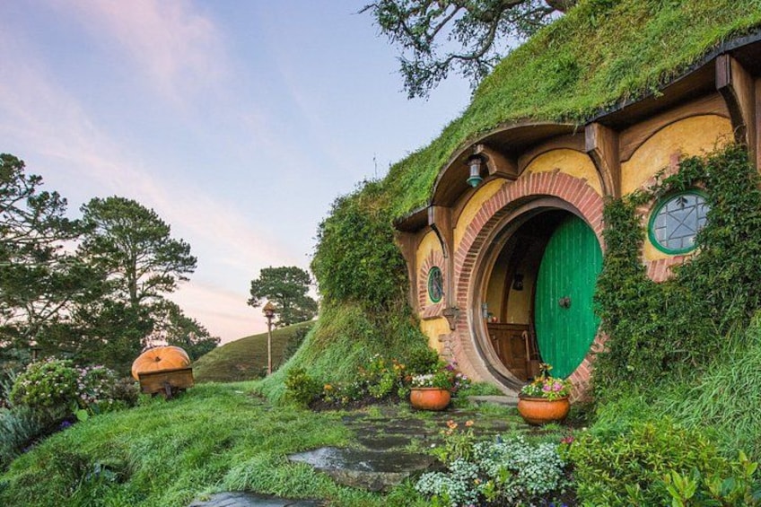 Hobbit-style houses with green doors and moss-covered roofs. 3