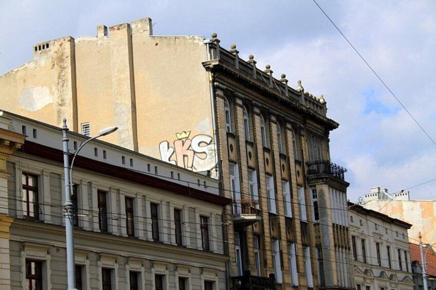 A historic building with classical architecture, including columns and a balcony. 4