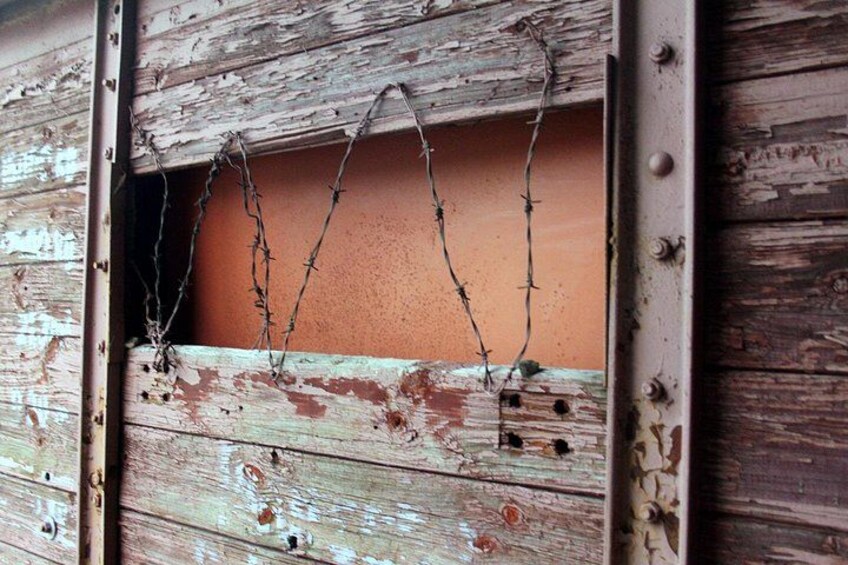 A weathered wooden structure with barbed wire. 3
