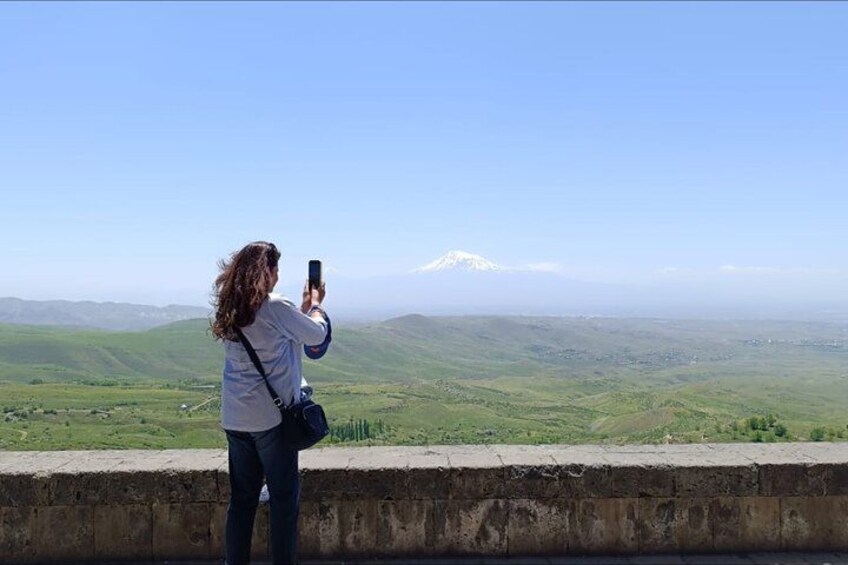 A person taking a photo of a mountain range. 3