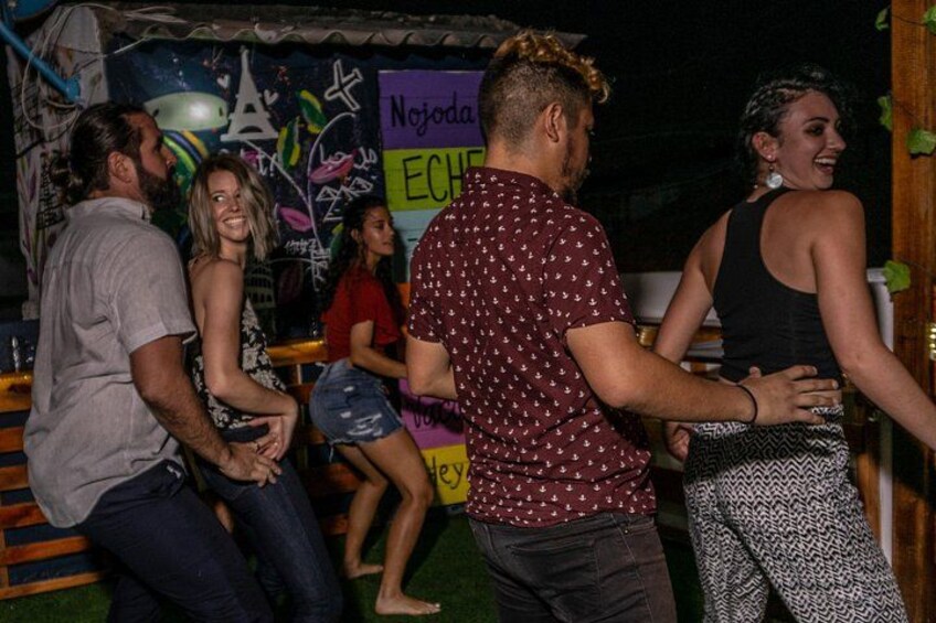 People dancing in a club with graffiti on the wall. 2