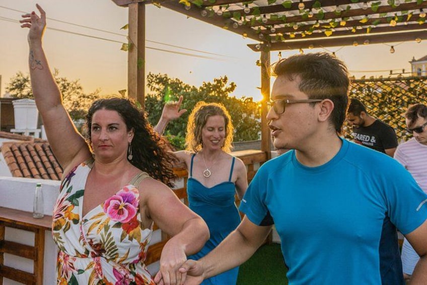 People dancing outdoors at sunset. 1