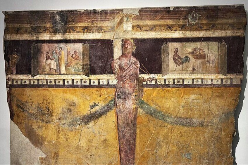 A fresco with a central figure, geometric patterns, and two smaller scenes in compartments. 5