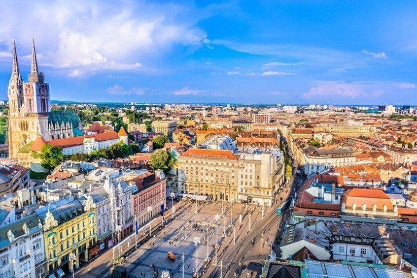 A cityscape with a prominent cathedral and a large square. 5