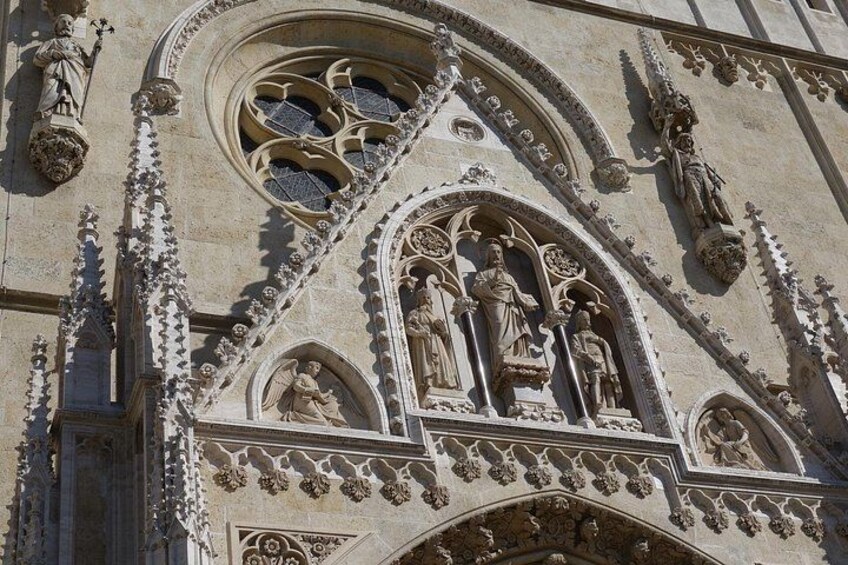 Intricate stone carvings and statues on a building facade. 4