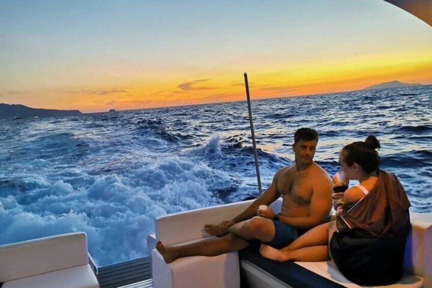 A couple on a boat with a sunset in the background. 5