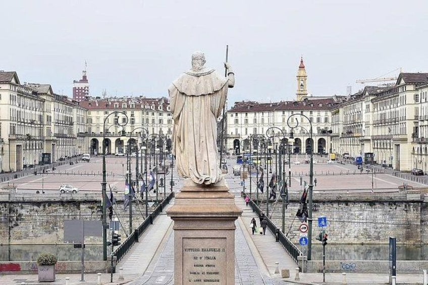A statue in a square with buildings in the background. 5