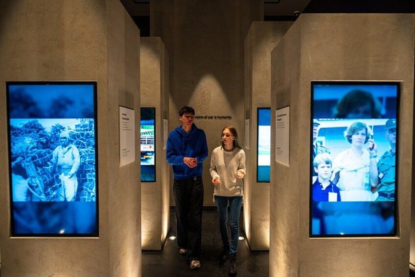 A corridor with two people standing between displays. 2