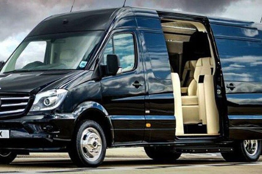 A black van with its side door open, revealing the interior. 2