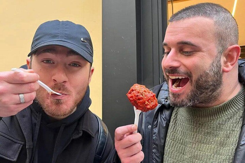 Two people eating ice cream cones outdoors. 2