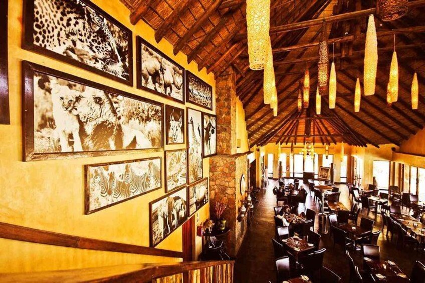 An interior with a high ceiling, wooden beams, and hanging light fixtures. 4