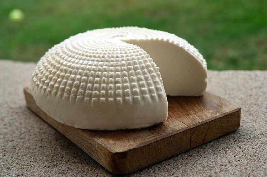 A white, textured object on a wooden board. 4