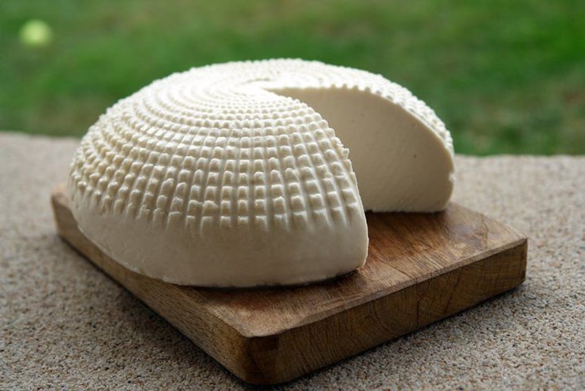 A white cheese on a wooden board. 2